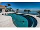 Sparkling pool with built in loungers overlooks the serene bay, blending relaxation with scenic beauty at 4998 62Nd S Ave, St Petersburg, FL 33715