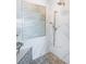 The walk-in shower features a marble tile surround and stylish accent tile with a mounted shower head at 4998 62Nd S Ave, St Petersburg, FL 33715