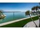 Scenic waterfront view features lush landscaping and a private dock on a bright and sunny day at 4998 62Nd S Ave, St Petersburg, FL 33715