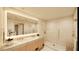 Modern bathroom with large mirror, double sink vanity, and glass enclosed shower at 5120 Marina Way # 21206, Tampa, FL 33611