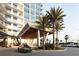 Modern building entrance with porte cochere, palm trees and luxury vehicle at 5120 Marina Way # 21206, Tampa, FL 33611