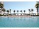 Beautiful in-ground pool with lounge chairs, palm trees, and pergolas at 5120 Marina Way # 21206, Tampa, FL 33611