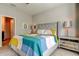 Cozy bedroom featuring a gray upholstered bed, soft carpet, and matching nightstands at 5243 6Th Way N, St Petersburg, FL 33703