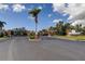 Gated community entrance featuring a Colonnade sign, brick pillars, palm trees, and well-maintained landscaping at 5243 6Th Way N, St Petersburg, FL 33703