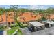 Aerial view of a residential area featuring well-maintained homes with red tile roofs and lush landscaping at 5310 Huntingwood Ct # 40, Sarasota, FL 34235