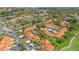 Aerial view of a condo community with a pool, parking, and scenic green spaces at 5310 Huntingwood Ct # 40, Sarasota, FL 34235