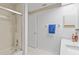 Bright bathroom with a shower/tub combo, neutral tiling, and decorative border around the room at 5310 Huntingwood Ct # 40, Sarasota, FL 34235
