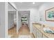 Bathroom with dual mirrors and granite countertops leads to bedroom with ample closet space at 5310 Huntingwood Ct # 40, Sarasota, FL 34235
