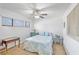 Bright bedroom with a comfortable bed, side tables, and a large window at 5310 Huntingwood Ct # 40, Sarasota, FL 34235
