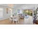 Cozy dining area with round table and chairs adjacent to the bright living room at 5310 Huntingwood Ct # 40, Sarasota, FL 34235