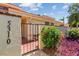 Inviting entryway with brick path, black gate, and lush plants leading to the front door at 5310 Huntingwood Ct # 40, Sarasota, FL 34235