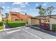 Charming home exterior featuring a red tile roof, lush landscaping, and a convenient carport at 5310 Huntingwood Ct # 40, Sarasota, FL 34235
