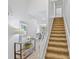 Bright foyer featuring a staircase, stylish console table, and a view into the living area at 5310 Huntingwood Ct # 40, Sarasota, FL 34235