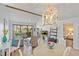 Open concept living room featuring vaulted ceilings, modern decor, and seamless flow into dining area at 5310 Huntingwood Ct # 40, Sarasota, FL 34235
