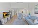 Open-concept living room with vaulted ceilings, wood floors, and coastal-inspired furnishings at 5310 Huntingwood Ct # 40, Sarasota, FL 34235
