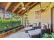 Relaxing screened-in patio with comfortable seating, decorative lighting, and lush greenery at 5310 Huntingwood Ct # 40, Sarasota, FL 34235