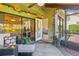Inviting screened patio with comfortable seating, decorative plants, and a ceiling fan at 5310 Huntingwood Ct # 40, Sarasota, FL 34235