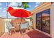 Outdoor patio with red brick flooring, comfortable seating, and an orange umbrella for shade at 5310 Huntingwood Ct # 40, Sarasota, FL 34235