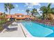 Community pool with lounge seating, privacy fencing, and mature landscaping at 5310 Huntingwood Ct # 40, Sarasota, FL 34235