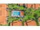 Aerial view of a community pool with lush landscaping and comfortable lounge seating at 5310 Huntingwood Ct # 40, Sarasota, FL 34235