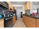 Well-lit kitchen with stainless steel appliances and wood cabinets at 5607 Larimer Dr, Tampa, FL 33615