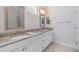 Bright bathroom featuring double sinks with granite counters and white cabinetry at 5734 Stockport St, Riverview, FL 33578