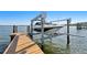 Boat on a lift on a wooden dock extending out into the water on a sunny day at 5905 Bayou Grande Ne Blvd, St Petersburg, FL 33703