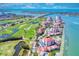 Scenic aerial view of a condo community with a golf course, waterfront, and bridge access at 6051 Sun Blvd # 601, St Petersburg, FL 33715