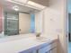 Bright bathroom featuring a white vanity with a large mirror and a shower tub combination at 6218 Greenleaf Ln # 6218, Temple Terrace, FL 33617