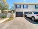 Home featuring a paved driveway, attached garage, and lush landscaping at 6218 Greenleaf Ln # 6218, Temple Terrace, FL 33617