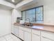 Well-lit kitchen featuring white cabinets, stainless steel sink, and a bright window for a fresh, clean feel at 6218 Greenleaf Ln # 6218, Temple Terrace, FL 33617