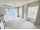 Sunlit living room with sliding glass doors, windows, and neutral carpet perfect for entertaining or relaxing at 6218 Greenleaf Ln # 6218, Temple Terrace, FL 33617