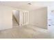 Spacious living room with staircase access and unique mirror accents enhancing the bright and airy ambiance at 6218 Greenleaf Ln # 6218, Temple Terrace, FL 33617