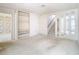 Bright living room featuring built-in shelving and staircase, offering both functionality and style at 6218 Greenleaf Ln # 6218, Temple Terrace, FL 33617