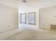 The living room is spacious with neutral carpet and abundant natural light from large windows at 6218 Greenleaf Ln # 6218, Temple Terrace, FL 33617