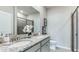 Modern bathroom featuring double sinks with granite countertops and a glass-enclosed shower at 711 157Th E Ct, Bradenton, FL 34212