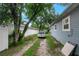 Backyard grassy driveway leading to street, showing yard and property details at 8413 N Hamner Ave # A, Tampa, FL 33604