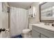 Clean bathroom featuring a vanity with cabinet storage, a toilet, and a shower with a patterned curtain at 8413 N Hamner Ave # A, Tampa, FL 33604