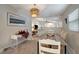 Bright dining room featuring a modern light fixture, neutral paint, and a desk/serving area at 8413 N Hamner Ave # A, Tampa, FL 33604