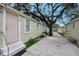 View of the exterior of the building with a large tree and walkway at 8413 N Hamner Ave # A, Tampa, FL 33604