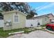 Exterior shot of a well-maintained home with a fenced yard, and parking at 8413 N Hamner Ave # A, Tampa, FL 33604