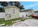 Exterior view of the building with white fence, parking area, and landscaping at 8413 N Hamner Ave # A, Tampa, FL 33604