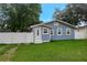 Exterior of blue home with a well-maintained lawn and white picket fence at 8413 N Hamner Ave # A, Tampa, FL 33604
