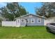 Well-manicured front lawn and blue cottage-style home with white-trimmed windows at 8413 N Hamner Ave # A, Tampa, FL 33604