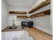 Compact kitchen area with open shelving, stainless steel microwave, and wooden countertops at 8413 N Hamner Ave # A, Tampa, FL 33604