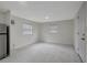 Open-concept living room featuring tile floors and stainless steel fridge at 8413 N Hamner Ave # A, Tampa, FL 33604