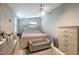 Main bedroom with a ceiling fan and padded bench at the foot of the bed at 8413 N Hamner Ave # A, Tampa, FL 33604