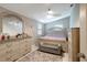 Primary bedroom featuring neutral walls and a padded bench at the end of the bed at 8413 N Hamner Ave # A, Tampa, FL 33604