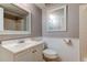 Bright bathroom with a vanity, toilet, and mirror at 10530 77Th Ter # 224, Seminole, FL 33772
