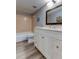Neutral bathroom with a white vanity, toilet, tub and modern flooring at 10530 77Th Ter # 224, Seminole, FL 33772